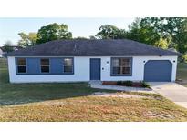 Charming single-story home with a well-maintained front yard and a cozy, inviting facade at 312 Oak Track Ter, Ocala, FL 34472