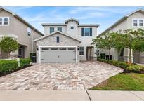 Charming two-story home with a stone accented garage and paver driveway at 416 Southfield St, Kissimmee, FL 34747
