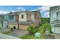 Charming two-story townhomes boasting attached garages, manicured lawns, and welcoming curb appeal at 6863 Tussilago Way, Orlando, FL 32822