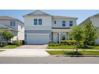 Charming two-story home with a well-manicured lawn, attached garage and inviting curb appeal at 13651 Rita Island, Orlando, FL 32827