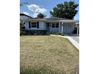 Charming single-story home with a well-maintained lawn and mature landscaping, with covered front entry at 1550 Palm Ave, Winter Park, FL 32789
