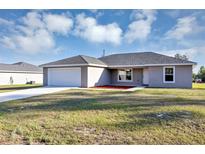 Charming single-story home featuring a two-car garage and landscaped yard at 16771 Sw 21St Terrace Rd, Ocala, FL 34473