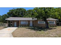 Charming single-story home with a well-maintained lawn and mature tree in the front yard at 2013 Sarazen Ct, Orlando, FL 32808