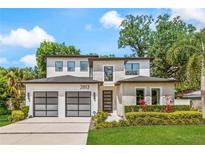 Modern two-story home with a well-manicured lawn, a two-car garage, and elegant exterior finishes at 2813 Northwood Blvd, Winter Park, FL 32789
