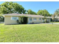 Charming single-story home boasts a lush green lawn and mature trees at 760 Eastridge Dr, Orange City, FL 32763