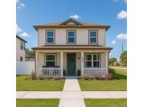 Charming two-story home featuring a welcoming front porch, verdant lawn, and well-maintained landscaping at 900 S Maple Ave, Sanford, FL 32771