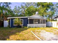 Charming single-story home with navy blue siding, white trim, and a cozy screened-in front porch at 1506 37Th St, Orlando, FL 32839