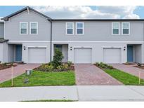 Charming townhomes feature brick driveways and beautifully landscaped front yards at 16447 Bird Of Paradise Ave, Clermont, FL 34714