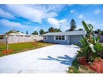 Charming single-story home with a well-manicured lawn, updated driveway, and lovely curb appeal at 8 Palm Dr, Ormond Beach, FL 32176