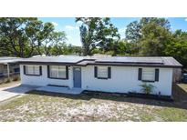 Charming single-story home featuring solar panels, a well-maintained lawn, and a freshly painted exterior at 1313 Pine Ridge Dr, Daytona Beach, FL 32117