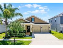 Charming single-Gathering home features a well-manicured lawn and an attached two-car garage at 15186 Book Club Rd, Winter Garden, FL 34787