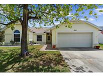 Charming single-story home with a two-car garage and well-maintained lawn at 2645 Debany Rd, Kissimmee, FL 34744