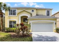 Charming two-story home with a well-manicured lawn and a spacious two-car garage at 2712 Lido Key Dr, Kissimmee, FL 34747