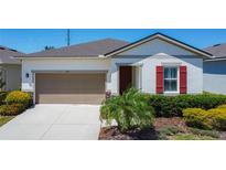 Inviting single-story home with a well-maintained lawn and neutral color palette at 308 Buchannan Dr, Davenport, FL 33837