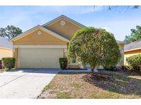 Charming single-story home features a two-car garage and a neatly maintained front yard at 4579 Westgrove Way, Orlando, FL 32808
