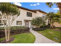 Charming two-story villa featuring lush landscaping, a walkway, and a cozy front entrance in a well-maintained neighborhood at 640 Killarney Bay Ct # 4, Winter Park, FL 32789