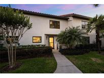 Charming two-story condo featuring well-maintained landscaping, mature trees, and a welcoming entrance at 640 Killarney Bay Ct # 4, Winter Park, FL 32789