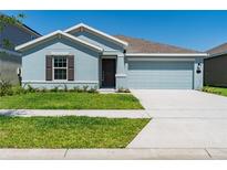 Charming single-story home with a well-manicured lawn and two-car garage at 917 Jackson Ave, Davenport, FL 33837