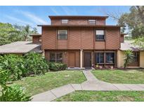 Two-story townhome featuring a well-maintained lawn and a symmetrical walkway leading to the front doors at 1005 Love Ln # 25, Apopka, FL 32703