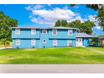 Inviting two-story home featuring a well-maintained lawn and a charming blue exterior at 1046 Blackwood St, Altamonte Springs, FL 32701
