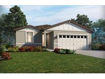 Charming single-story home featuring a two-car garage and beautifully landscaped front yard at 109 Archer Ave, Lake Alfred, FL 33850