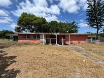 Single story home with a small covered porch and needing repairs in an established neighborhood on a sunny day at 122 Laurel Dr, Sanford, FL 32773
