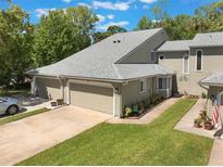 Charming two-story townhouse featuring a two-car garage and well-maintained lawn and landscape at 35 Misners Trl, Ormond Beach, FL 32174