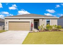 Charming single-story home with a well-manicured lawn and a two car garage at 3761 Shoveler Ave, Leesburg, FL 34748