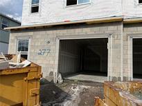 View of a new construction home with an attached, two-car garage still undergoing the building process at 4291 Campsite Loop, Orlando, FL 32824