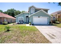 Charming two-story home boasts a well-maintained lawn and a welcoming two-car garage at 4381 Creekside Blvd, Kissimmee, FL 34746