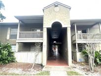 Inviting condo complex with central walkway, balconies, and mature landscaping at 455 Wymore Rd # 203, Altamonte Springs, FL 32714