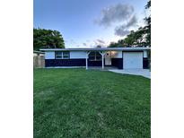 Charming single-story home featuring a well-manicured front lawn and welcoming entrance at 637 Ash Ave, Daytona Beach, FL 32117