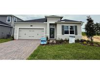 Charming single-story home with a two-car garage and a well-manicured front yard at 738 Pointe Emerson Blvd, Apopka, FL 32703