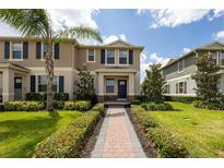 Inviting two-story home with a brick walkway, lush landscaping, and a pleasant facade at 16261 Admirals Cove Ln, Winter Garden, FL 34787