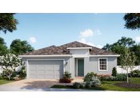 Charming single-story home with a gray exterior, two-car garage, and beautifully landscaped front yard at 1785 Columbus Path, St Cloud, FL 34771