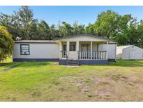 Charming single-story home featuring a covered front porch and a large yard at 1981 N County Road 426, Oviedo, FL 32765