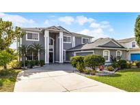 Stunning two-story home features a manicured lawn and beautiful landscaping at 346 Willet Ave, Apopka, FL 32703