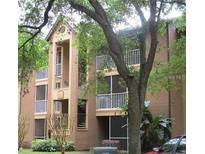 Condominium exterior with balconies and mature trees in a well-maintained community at 625 Dory Ln # 204, Altamonte Springs, FL 32714