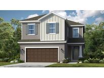 Charming two-story home featuring a two-car garage and inviting front entrance at 1048 Teal Creek St, St Cloud, FL 34771