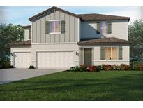 Two-story home with a two car garage, neutral color palette and manicured front yard at 2356 Citrus Bloom Dr, Bartow, FL 33830