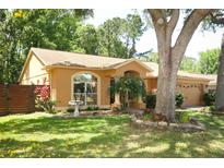 Charming single-story home featuring a landscaped yard and a side-entry garage at 304 Little Springs Ln, Longwood, FL 32750