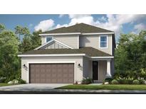 Charming two-story home featuring a symmetrical facade, a two-car garage, and neatly manicured landscaping at 1042 Teal Creek Dr, St Cloud, FL 34771