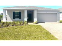 Charming single-story home featuring a well-manicured lawn, neutral paint and attached two car garage at 141 Addle Hill Ct, Deland, FL 32720