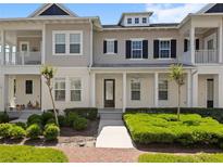 Inviting townhome with a well manicured lawn, covered entry, and stylish architectural details at 1516 Resolute St, Celebration, FL 34747