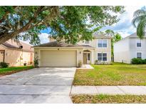 Charming two-story home with a manicured lawn and a two-car garage at 4113 Stonefield Dr, Orlando, FL 32826