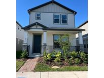 Charming two-story home with a covered front porch and neatly landscaped front yard at 4716 Homestead Trl, St Cloud, FL 34772