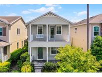 Charming two-story home with a covered porch and manicured landscaping at 5711 Hamlin Groves Trl, Winter Garden, FL 34787