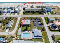 An aerial view showcasing beach access and community pool and parking at 865 Ladyfish Ave # C104, New Smyrna Beach, FL 32169