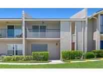 Light tan condo with balcony, decorative trim, and green landscaping at 1152 Grove St, Maitland, FL 32751
