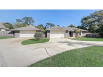 Charming home boasts a two-car garage and well-manicured lawn at 1155 Collins Ave, Orange City, FL 32763